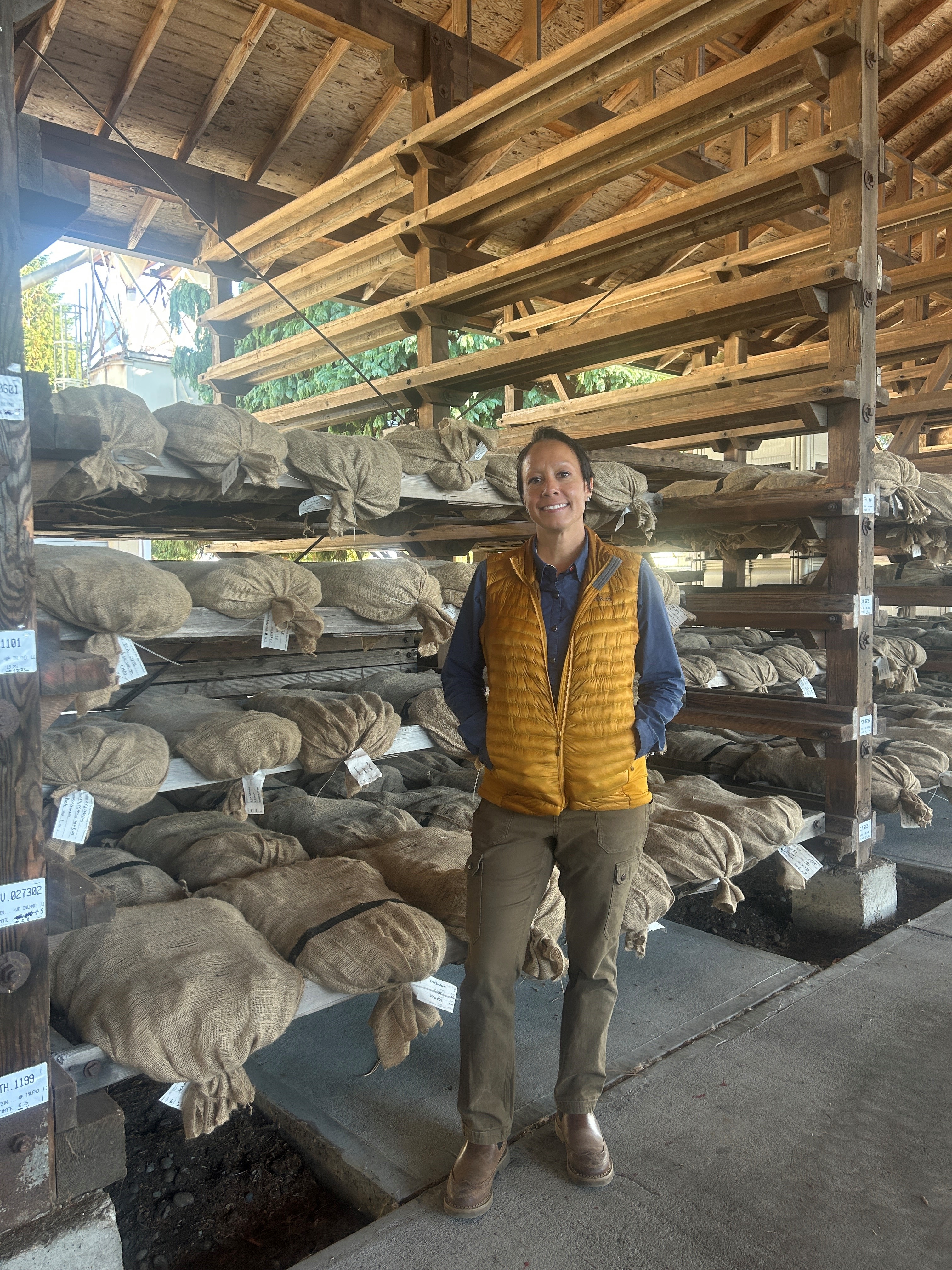 Image of Viviana with bagged cones awaiting their turn through the seed plant. Image of Viviana and her husband as ambassadors for this year's Girlfriends Run for a Cure during Breast Cancer Awareness month.