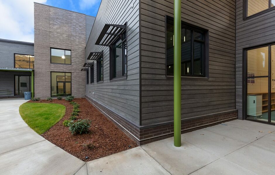 Image of the exterior of a home built with wood and wood shingling on the exterior.
